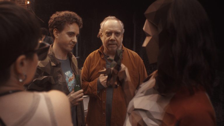 Declan Mason and Paul Giamatti enter into a photograph in the Black Mirror episode "Eulogy."